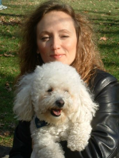Happy woman with Bichon Frise after energy healing healed her dog of Lyme disease.